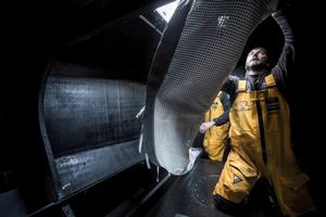 Onboard Abu Dhabi Ocean Racing - Ian Walker helps stack sails down and forward in prep for a gybing battle north of the ice gates overnight - Leg five to Itajai -  Volvo Ocean Race 2015 photo copyright Matt Knighton/Abu Dhabi Ocean Racing taken at  and featuring the  class