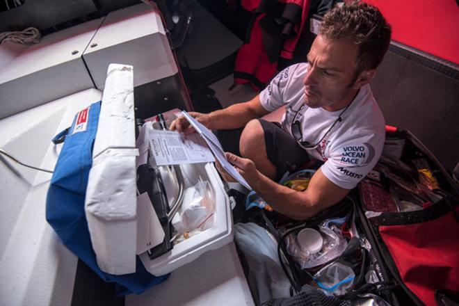 April 20,2015. Leg 6 to Newport onboard Dongfeng Race Team. Day 1. A broken water maker. Eric Peron reads the instructions for the spare. © Sam Greenfield/Dongfeng Race Team/Volvo Ocean Race