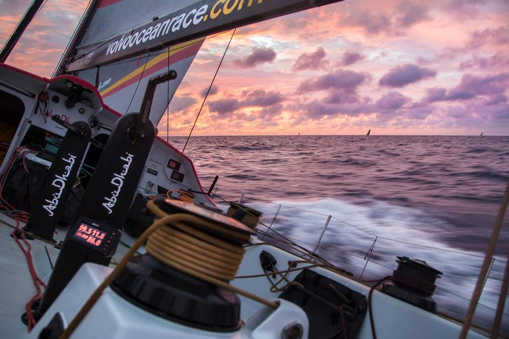 April 21, 2015. Leg 6 to Newport onboard Abu Dhabi Ocean Racing. Day 2.  Sunrise on day 2 of the race to Newport and the entire fleet is silhouetted against a pink sky. © Matt Knighton/Abu Dhabi Ocean Racing