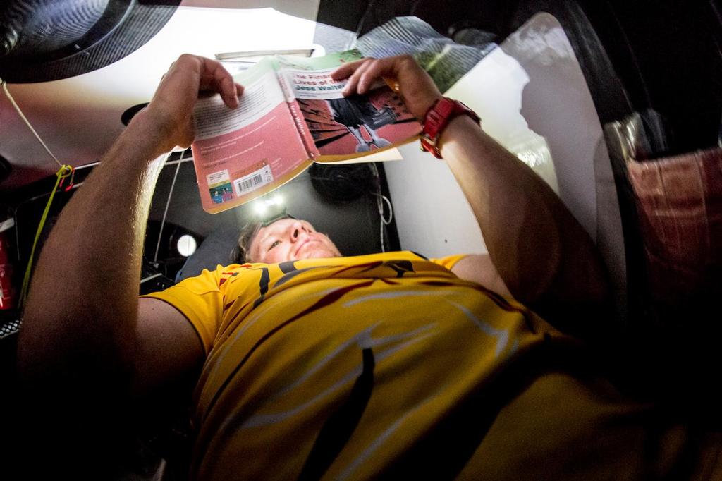 April 21, 2015. Leg 6 to Newport onboard Abu Dhabi Ocean Racing. Day 2.  Sleeping patterns haven't set in yet so Luke 'Parko' Parkinson takes a moment of his free time to squeeze a little reading in the upper bunk. © Matt Knighton/Abu Dhabi Ocean Racing
