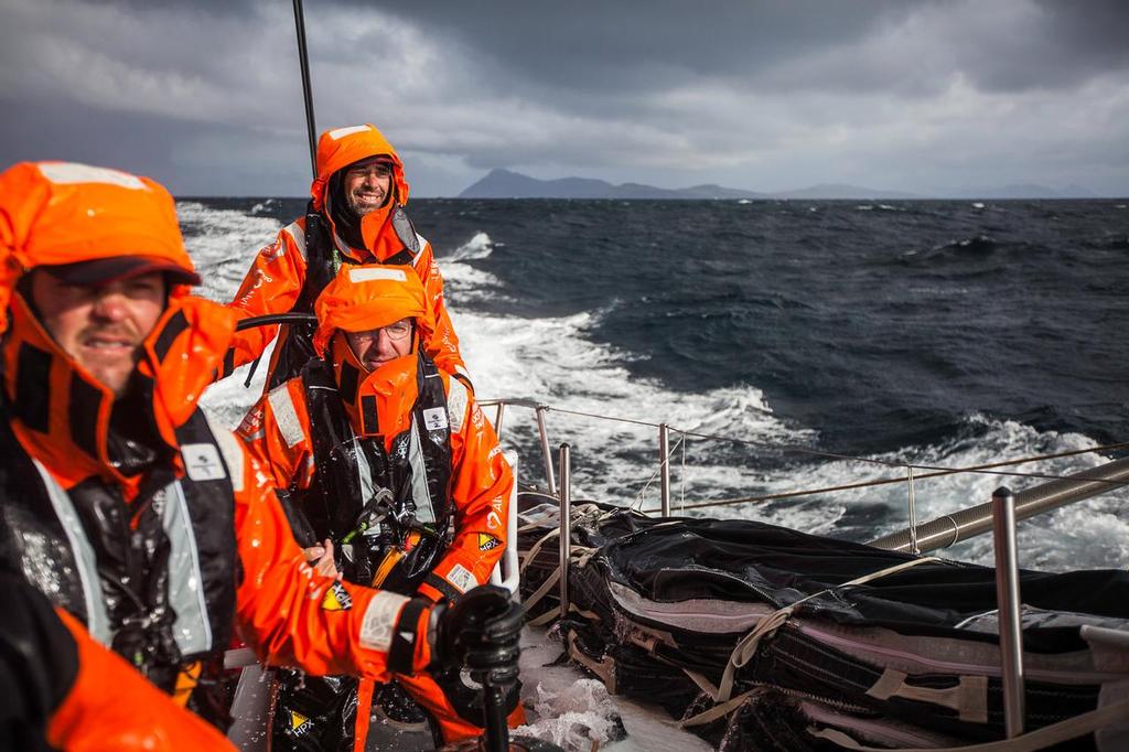 March 30, 2015. Leg 5 to Itajai onboard Team Alvimedica. Day 13. Stu Bannatyne and Will Oxley smile in the warm sun with Cape Horn fading in the distance. Team Alvimedica is the first boat to round the fabled Cape Horn before turning north to an immediately different environment--light air and sunshine.  ©  Amory Ross / Team Alvimedica