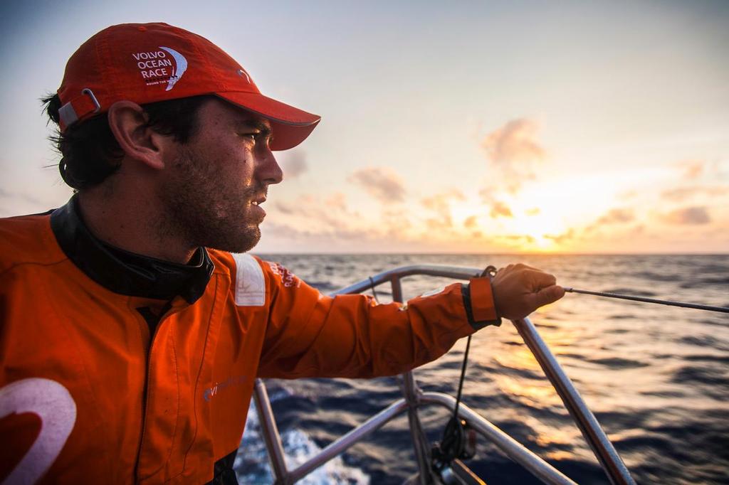 April 21, 2015. Leg 6 to Newport onboard Team Alvimedica. Day 02. The drag race east continues as the fleet tries to outrun a cold front coming from the west, bringing stronger winds and wetter conditions. Mark Towill takes a moment to enjoy the pleasant view from the back of the boat as another day at sea winds down. ©  Amory Ross / Team Alvimedica