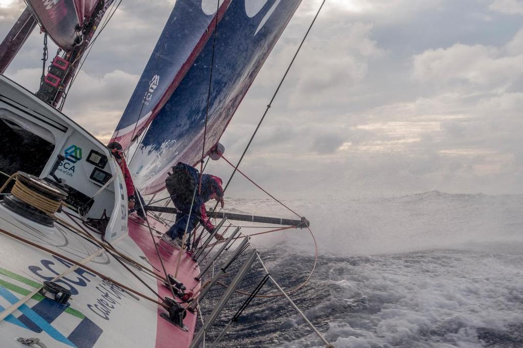April 21, 2015. Leg 6 to Newport onboard Team SCA. Day 2. Justine Mettraux rigs up the outrigger on to the J1 as the team continue to sail in a fast up wind mode with the rest of the fleet. © Corinna Halloran / Team SCA