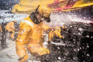 Leg six to Newport onboard Abu Dhabi Ocean Racing. Day 10. Daryl Wislang and Adil Khalid take on the firehose while putting in a reef in the Atlantic Ocean. - Volvo Ocean Race 2015 photo copyright Matt Knighton/Abu Dhabi Ocean Racing taken at  and featuring the  class
