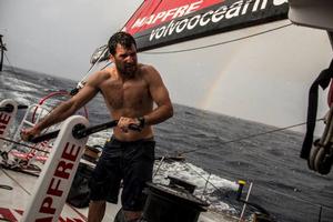 Onboard MAPFRE – Sailing, rain, rainbows what else we can ask! Carlos Hernandez at the grinder - Volvo Ocean Race 2015 photo copyright Francisco Vignale/Mapfre/Volvo Ocean Race taken at  and featuring the  class