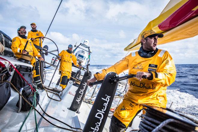 Leg 6 to Newport onboard Abu Dhabi Ocean Racing. Day 15. Phil Harmer cranks on the new sheet after a sail change as speed builds en route to Newport.  © Matt Knighton/Abu Dhabi Ocean Racing