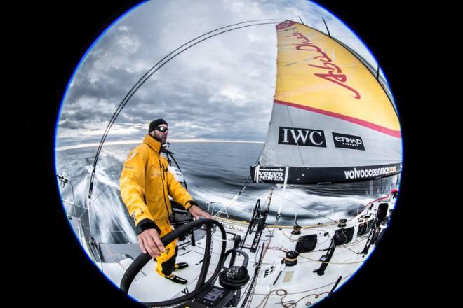 Leg 7 to Lisbon onboard Abu Dhabi Ocean Racing. Day 3. 8mm circular fisheye shot of Ian Walker driving at sunset in the Atlantic Ocean. - Volvo Ocean Race 2015 © Matt Knighton/Abu Dhabi Ocean Racing