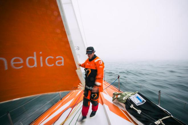 Leg 7 to Lisbon onboard Team Alvimedica. Day 06. Nick Dana walks back from the bow in dense fog. After days of sailing next to each other along the southern Ice Limit,the fleet spreads out north-south with varying opinions about how to approach the Azores High,an area of light winds sitting in the path to Lisbon.  ©  Amory Ross / Team Alvimedica
