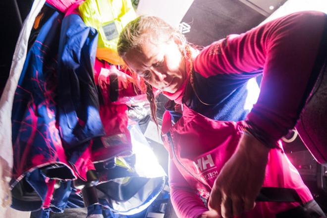Leg 7 to Lisbon onboard Team SCA. Day 01. Sophie Ciszek removing her watch after finishing her watch on deck © Anna-Lena Elled/Team SCA