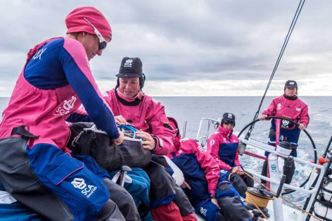 Leg 7 to Lisbon onboard Team SCA. Day 03. Justine Mettraux and Carolijn Brouwer packing sheets. - Volvo Ocean Race 2015 © Anna-Lena Elled/Team SCA