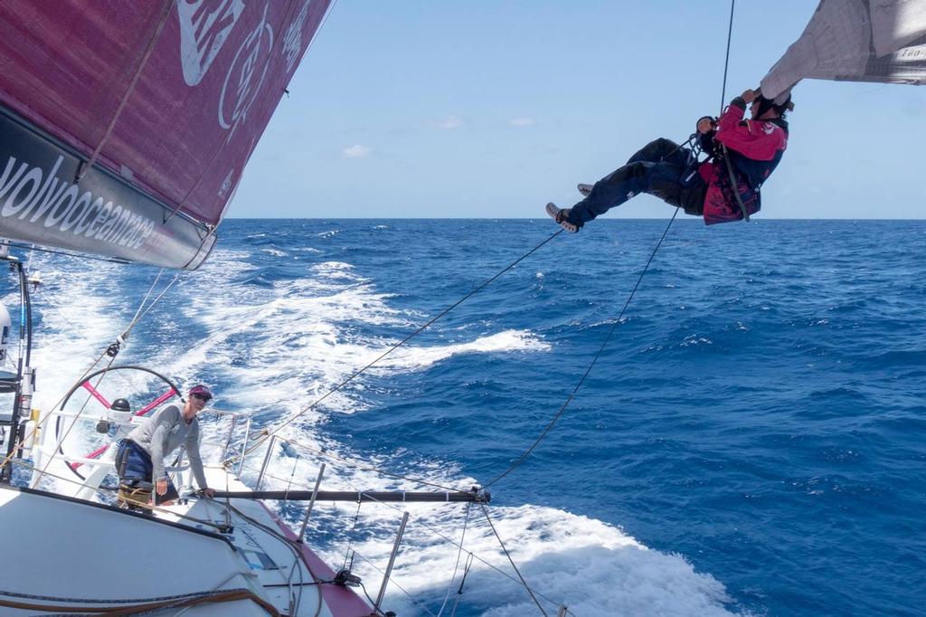 April 30, 2015. Leg 6 to Newport onboard Team SCA. Day 10. Stacey Jackson goes out to the FR0 clew to add a new sheet. © Corinna Halloran / Team SCA