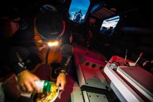 Leg 7 to Lisbon onboard Team Alvimedica. Day 03. Charlie Enright douses his Pasta Primavera in parmesan cheese before a late night meal. Approaching the southern limits of the Greenland Ice Exclusion Zone the fleet compresses further,all six within sight of each other. - Volvo Ocean Race 2015 photo copyright  Amory Ross / Team Alvimedica taken at  and featuring the  class