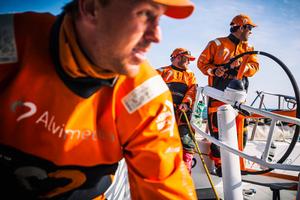  Leg 7 to Lisbon onboard Team Alvimedica. Day 05. Dave Swete (L),Ryan Houston (M),and Mark Towill (R) stare in unison at Abu Dhabi to the west,executing a peel from their Masthead Code Zero to their A3 spinnaker. The racing has been so close that the crew spend much of their time looking at other boats,rather than focusing on sailing their own. The drag race northeast towards the eastern edge of the ice exclusion zone continues with the front five all still within a few miles of each other. photo copyright  Amory Ross / Team Alvimedica taken at  and featuring the  class