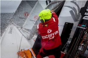 Leg 08 to Lisbon onboard Dongfeng Race Team. Day 16. Kevin Escoffier removing a sail from the bow after a sail change. - Volvo Ocean Race 2015 photo copyright Yann Riou / Dongfeng Race Team taken at  and featuring the  class