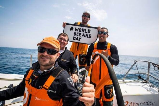 Onboard Team Alvimedica – Team Alvimedica celebrates #WORLDOCEANSDAY from the North Atlantic after a morning of playing with dolphins. (L to R - Ryan Houston, Will Oxley, Charlie Enright, Mark Towill). - Leg 8 to Lorient – Volvo Ocean Race 2015 ©  Amory Ross / Team Alvimedica