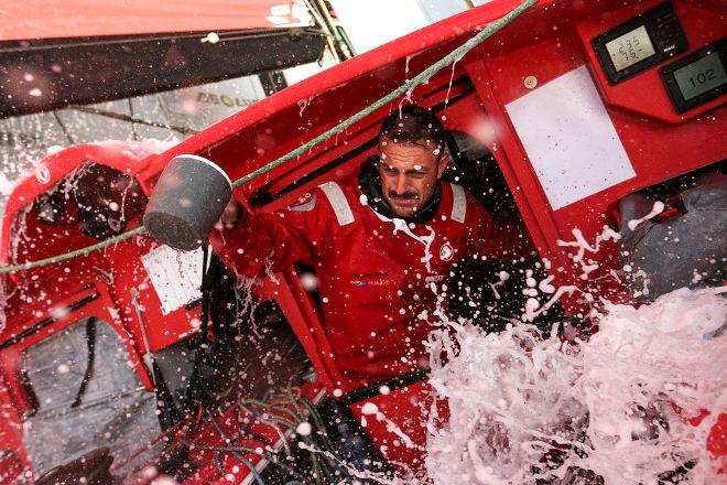 Wet conditions onboard for Eric Peron as he even uses it to his advantage to wash the dishes! - 2015 Volvo Ocean Race © Yann Riou / Dongfeng Race Team