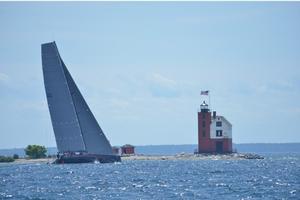 Il Mostro finishing at Round Island Lighthouse. - Bell’s Beer Bayview Mackinac Race photo copyright Martin Chumiecki / Bayview Yacht Club taken at  and featuring the  class