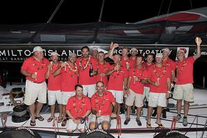 Mark Richards (with champagne bottle), and Roy P. Disney (on his right), celebrate with the crew aboard Wild Oats XI following the finish of the Transpac Race from Los Angeles to Honolulu photo copyright  Sharon Green / Ultimate Sailing taken at  and featuring the  class