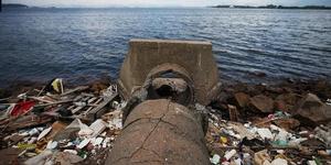 Rio De Janeiro, Brazil - An abandoned drainage pipe sits on the edge of polluted Guanabara Bay in Rio de Janeiro, Brazil. The city is taking on a number of infrastructure projects and cleaning up Guanabara Bay, site of Olympic sailing events - Rio 2016 Olympic Games photo copyright Mario Tama/Getty Images taken at  and featuring the  class