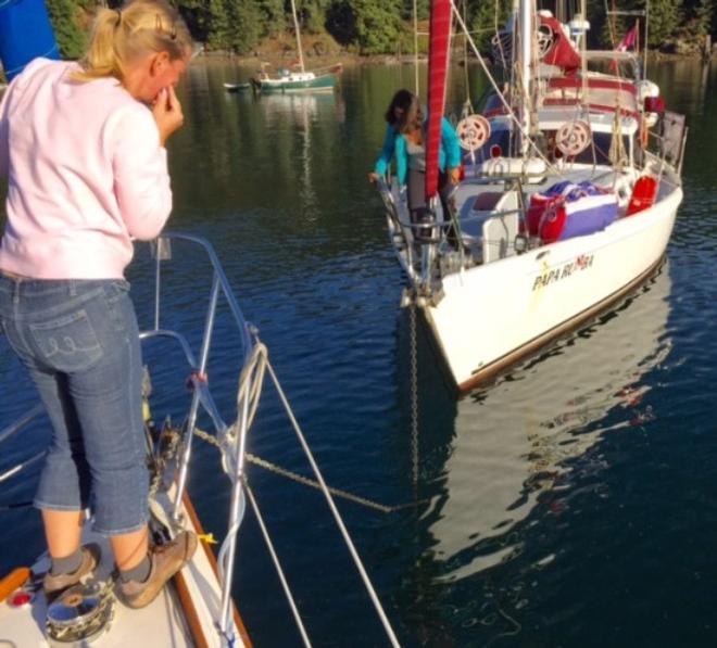 Heather on Blue Rose and Amanda on Papa Rumba patiently untangling the anchor rodes. - 2015 Peterson Cup Cruising Rally © Bluewater Cruising Association
