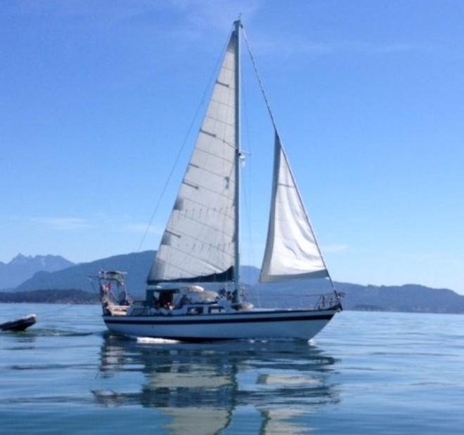 Alia motor-sailing on a glassy Salish Sea, headed for ‘Isla des Acorn-Hornos’. - 2015 Peterson Cup Cruising Rally © Bluewater Cruising Association