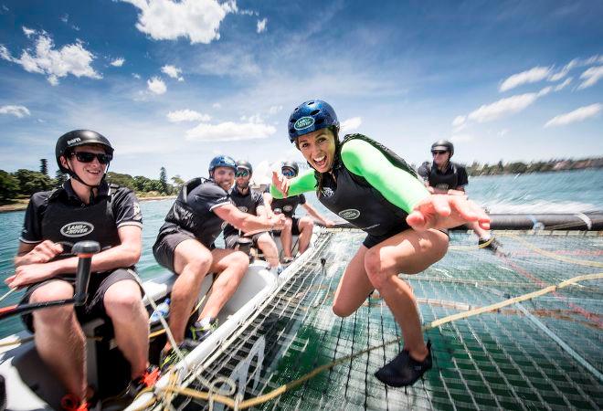 Land Rover Australia ambassador Sally Fitzgibbons ’surfs’ the Land Rover Extreme 40 as fellow ambassador Phil Waugh puts his sailing skills to the test - 2015 Extreme Sailing Series © Lloyd Images