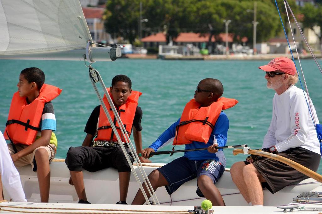 The USA’s Dave Dellenbaugh (far right) mentors young sailors from Addelita Cancryn Jr. High in the Carlos Aguilar Match Race Youth Regatta. © Dean Barnes