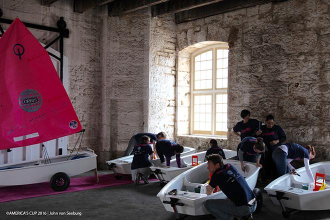 Volunteers put the finishing touches on Optimist dinghies which have been restored by Oracle Team USA and gifted to AC Endeavour graduates. © Oracle Team USA / John Von Seeburg