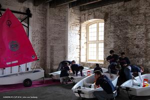 Volunteers put the finishing touches on Optimist dinghies which have been restored by Oracle Team USA and gifted to AC Endeavour graduates. photo copyright Oracle Team USA / John Von Seeburg taken at  and featuring the  class