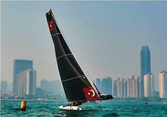 Team Turx fly a hull during racing on Fushan Bay in Qingdao © Aitor Alcalde Colomer