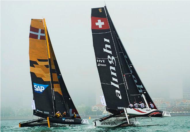 SAP Extreme Sailing Team and Alinghi flying hulls on the water in Fushan Bay for Act two, Qingdao. © Aitor Alcalde Colomer