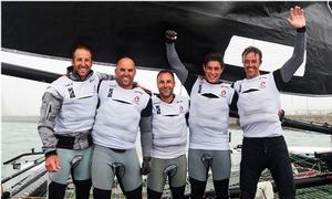 The crew of Alinghi, skippered by Arnaud Psarofaghis, celebrate their Act win on board their GC32 in Qingdao. photo copyright Aitor Alcalde Colomer taken at  and featuring the  class