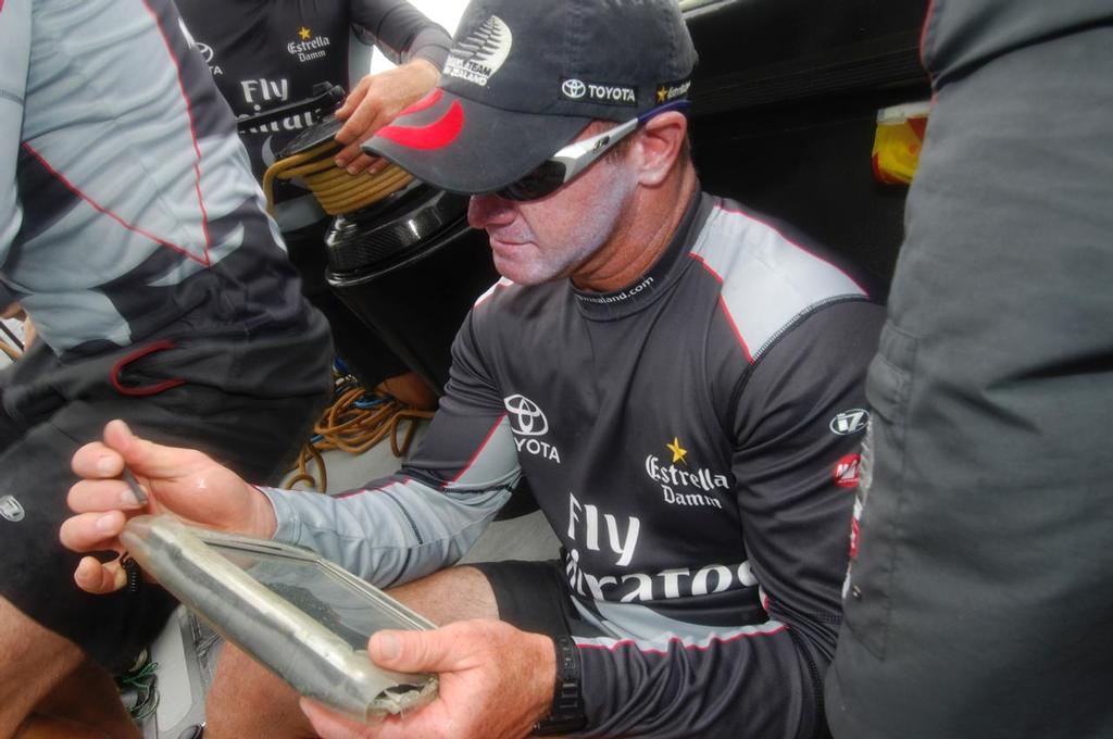 Emirates Team New Zealand navigator Kevin Hall using a Panasonic Tough Book Tablet computer aboard NZL84 during a practice session. Valencia 27/7/2006 photo copyright Chris Cameron www.chriscameron.co.nz taken at  and featuring the  class