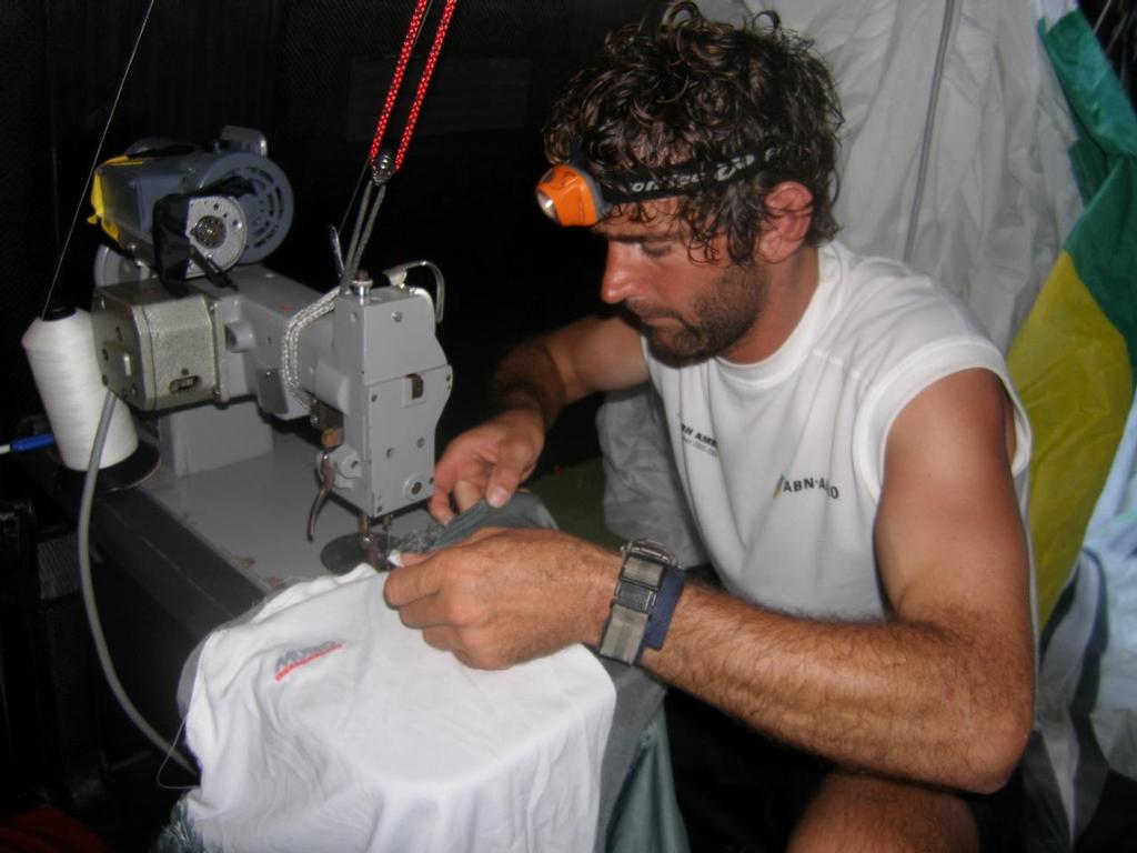 Hans Horrevoets gets more than sails to repair below decks on Volvo Open 70 ABN AMRO TWO here he sews up a crewmans t shirt © Volvo Ocean Race http://www.volvooceanrace.com