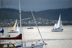 Division three leaders sail past moored yachts in Sandy Bay photo copyright  Peter Campbell taken at  and featuring the  class