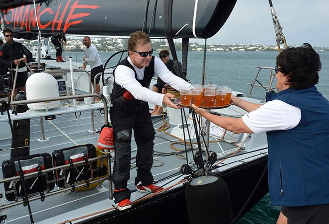 Dark 'n Stormies all round! Leatrice Oatley, Commodore of the Royal Bermuda YC hands Ken Read, skipper of COMANCHE crew rations to celebrate their record run.  © Barry Pickthall / PPL