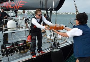Dark 'n Stormies all round! Leatrice Oatley, Commodore of the Royal Bermuda YC hands Ken Read, skipper of COMANCHE crew rations to celebrate their record run. photo copyright Barry Pickthall / PPL taken at  and featuring the  class
