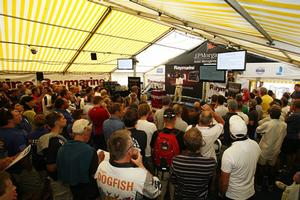 Attracting a crowd for the all-important Raymarine Weather Briefing, Chris Tibbs addresses a packed ISC marquee - 2016 J.P. Morgan Asset Management Round the Island Race photo copyright Patrick Eden taken at  and featuring the  class