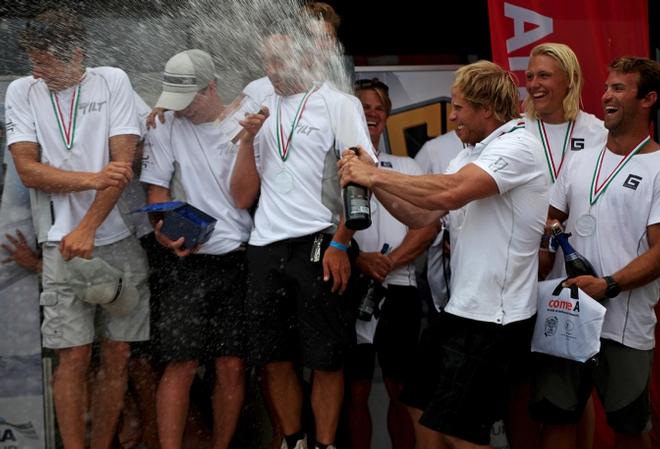 Arnaud Psarofaghis and the winning crew of Team Tilt get sprayed – GC32 Malcesine Cup ©  Max Ranchi Photography http://www.maxranchi.com