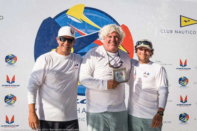 Rob Wilber (center) and his Cinghiale team featuring Sam Rogers (left) and Ben Allen (right) happily accept their daily award for winning Race Five. © Barracuda Communications