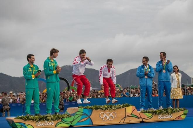 Sime Fantela and Igor Marenic (CRO) arrive on the podium for their gold medals - Rio 2016 Olympic Sailing Competition © Matias Capizzano http://www.capizzano.com