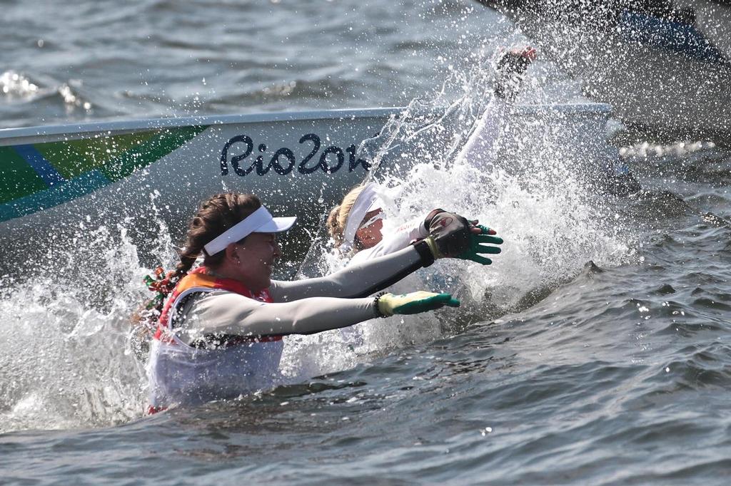 Annalise Murphy (IRL) and Bronze medalist Anne-Marie Random jump into the turgid water of Guanbara Bay after the Laser Radial Medal Race photo copyright Richard Gladwell www.photosport.co.nz taken at  and featuring the  class