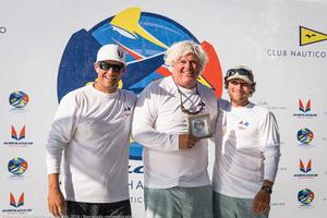 Rob Wilber (center) and his Cinghiale team featuring Sam Rogers (left) and Ben Allen (right) happily accept their daily award for winning Race Five. photo copyright Barracuda Communications taken at  and featuring the  class