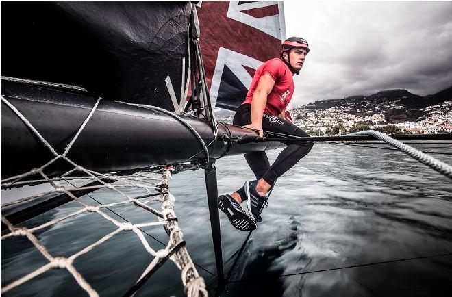 Act 6, Extreme Sailing Series Madeira – Day 1 – Land Rover BAR Academy skipper Neil Hunter on the bow of the team's catamaran on the opening day in the Madeira Islands. © Lloyd Images