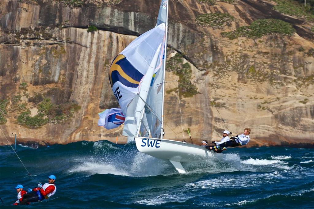 The Swedish mens crew launch in the 20-25kts winds and 3-4 metre Atlantic Ocean swells heading for the finish of Race 3 of the Mens 470, 2016 Olympics. With the Australian crew to leeward and the Greek crew ahead. A race management boat is visible with just its aerials showing. photo copyright Richard Gladwell www.photosport.co.nz taken at  and featuring the  class