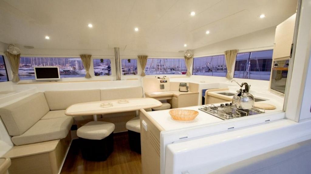 Galley and dining area aboard catamaran - America's Cup live-aboard tour packages © SW