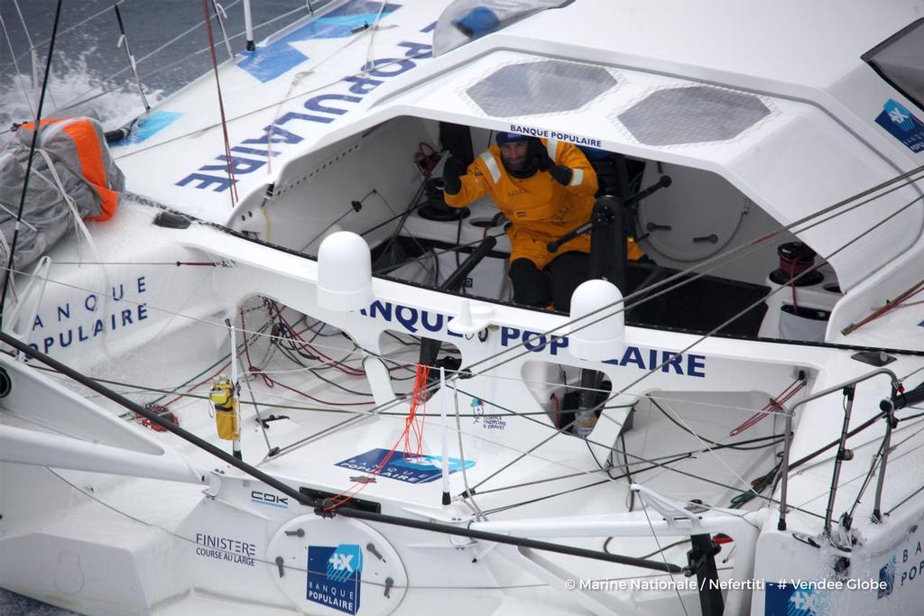 Banque Populaire VIII, skipper Armel Le Cleac’h (FRA), off the Kerguelen Islands, flown over by the National French Marine Nivose Frigate, during the Vendee Globe, solo sailing race around the world, on November 30th, 2016 photo copyright Marine Nationale / Nefertiti / Vendee Globe vendeeglobe.org taken at  and featuring the  class