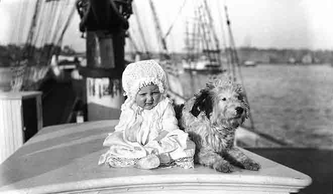 Baby and dog on a sailing ship  about 1910 © Sam Hood