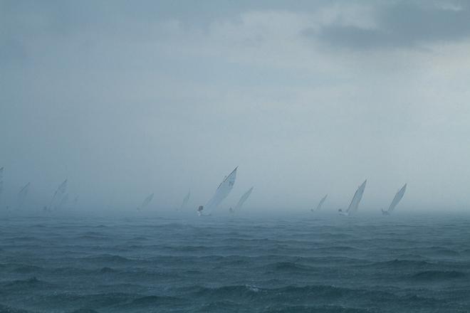 The fleet disappearing into the rain. - Mercedes Benz Mornington Couta Boat National Championships ©  Alex McKinnon Photography http://www.alexmckinnonphotography.com
