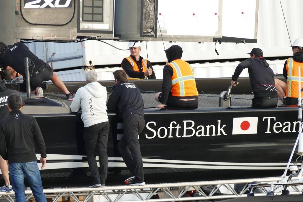 Dean Barker (Softbank Team Japan) and Grant Simmer (Oracle Team USA) look over Softbank Team Japan’s new AC50 in Bermuda. © SW